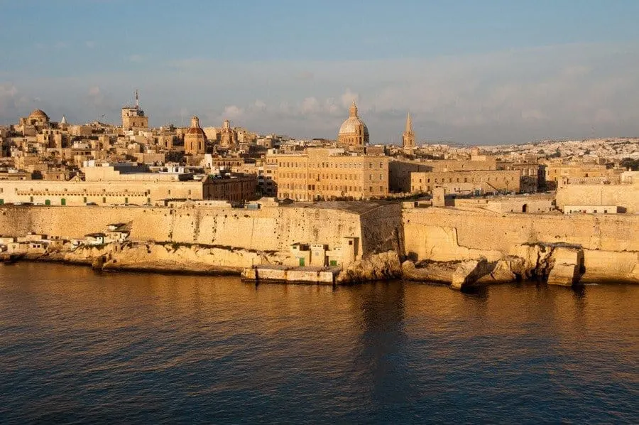 Valletta Grand Harbour skyline at golden hour, framed by historic fortifications
